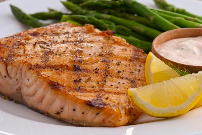 Our freshly prepared fish is paired with fresh lemon wedges to add a special touch and asparagus.