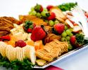 Cheese and cracker platter paired with fresh strawberries and grapes.