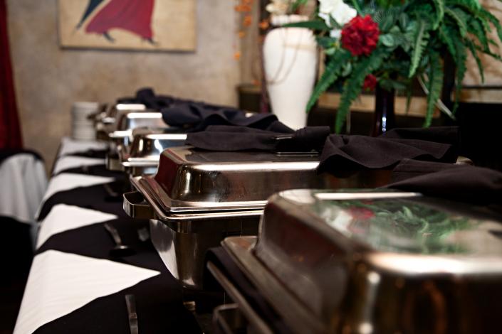 A row of delicious, catered food trays just waiting to be opened by your party or wedding guests.