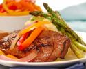 Beef entree prepared with fresh asparagus and bell peppers.