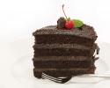 Layered chocolate cake with a cherry on top